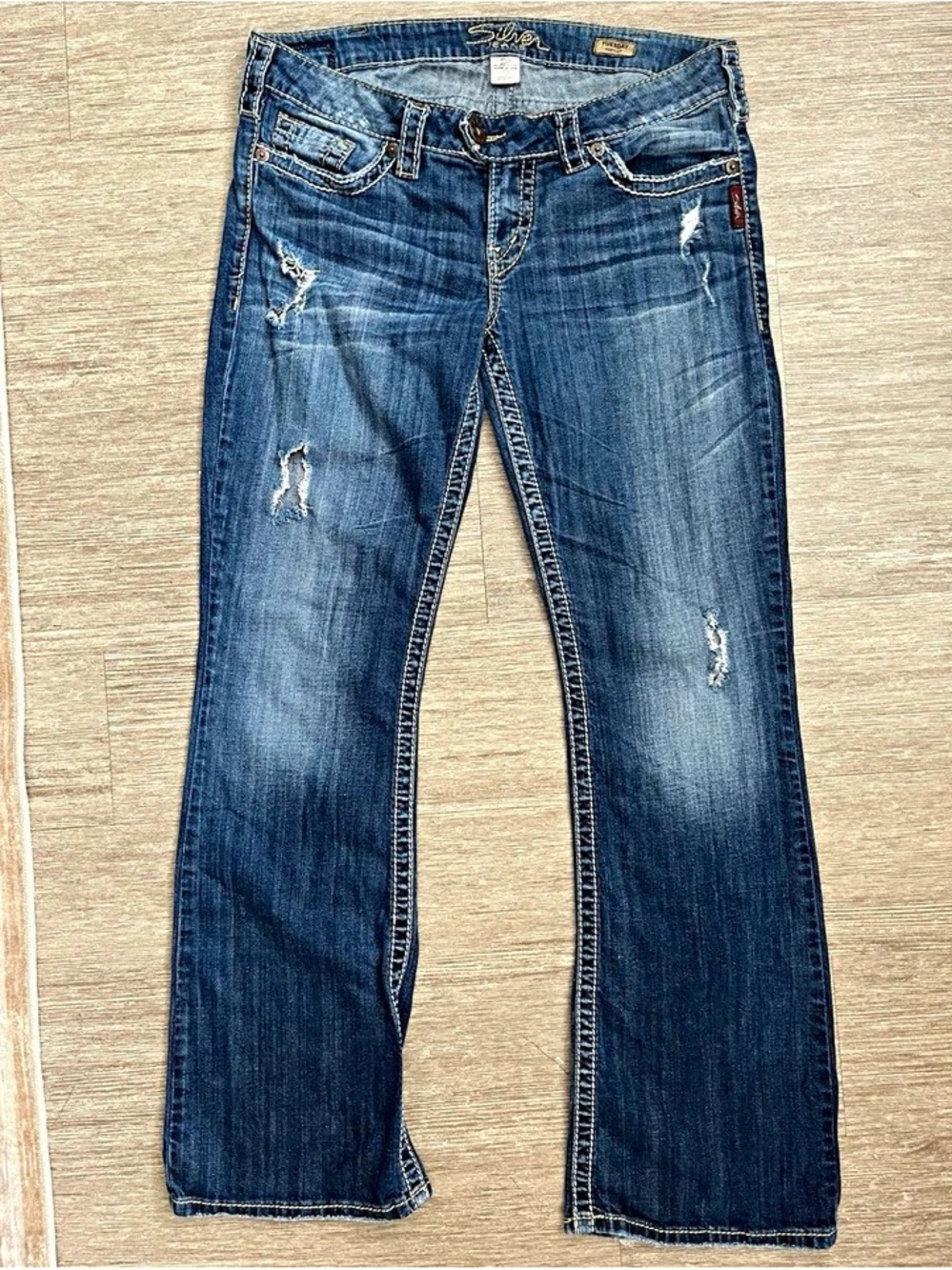 Silver Jeans Women's Flare Jeans in Dark Blue Wash with Distressing